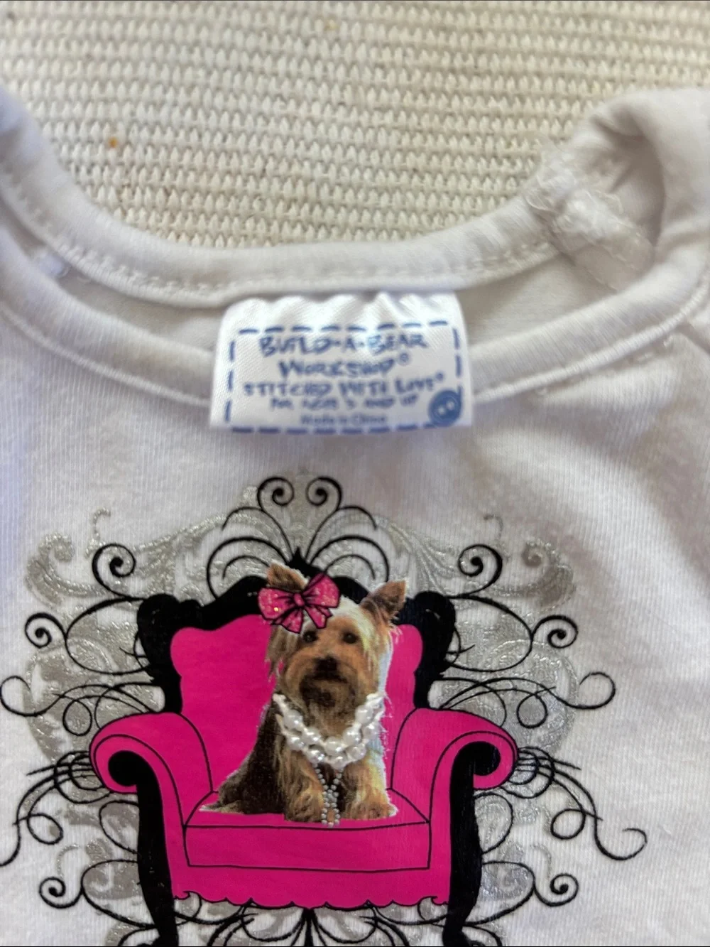 Build-A-Bear outfit featuring a graphic dog tee and a pink plaid ruffled skirt.